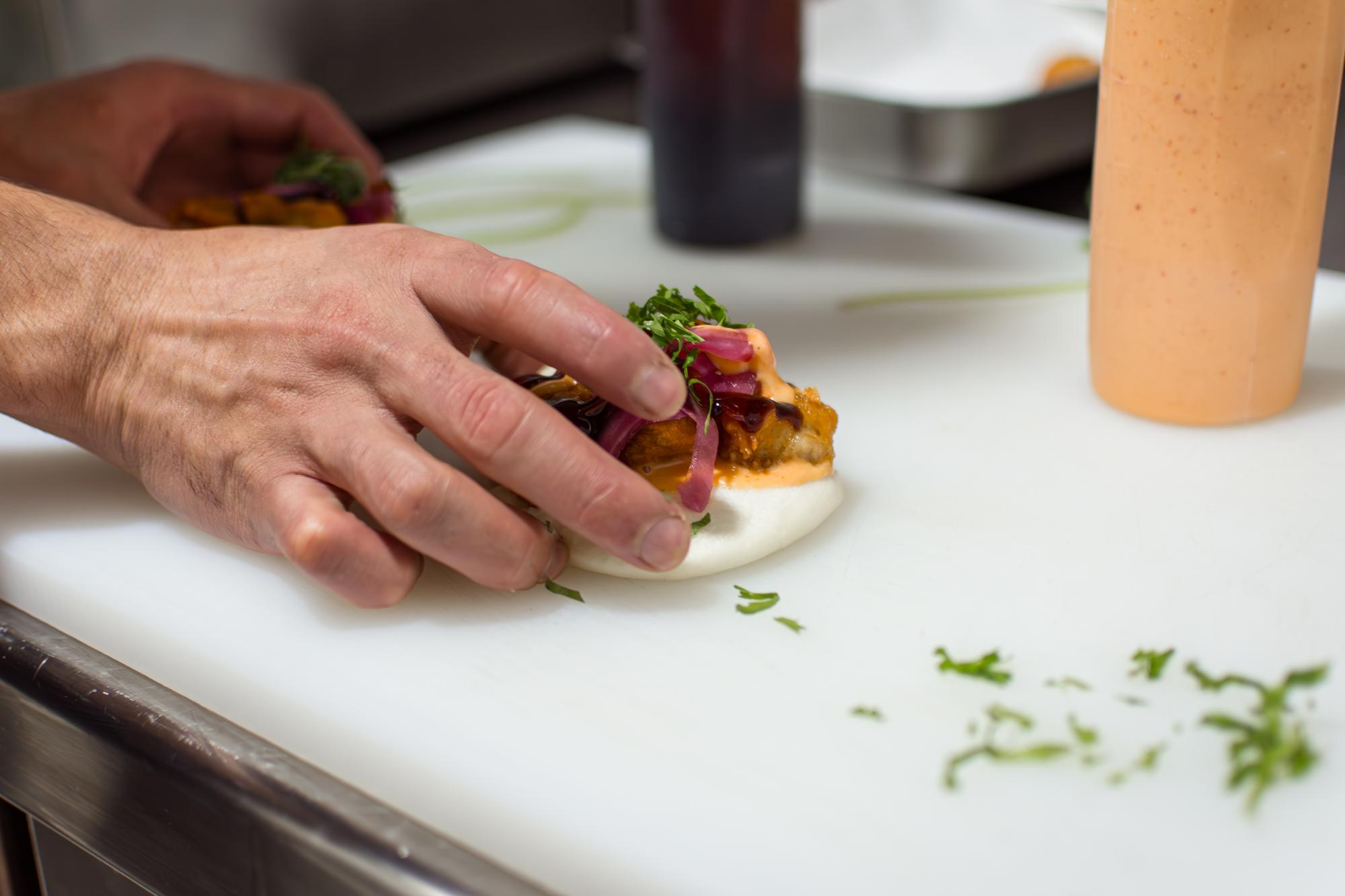 Chef hands arranging garnish